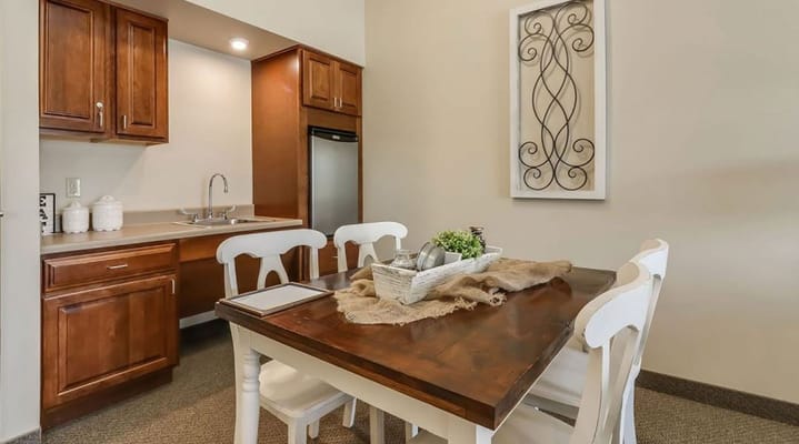 Cozy dining area featuring a wooden table and modern kitchen cabinets
