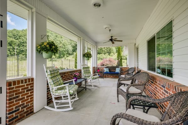 Covered porch with rocking chairs and potted plants