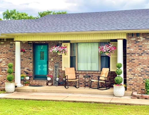 Exterior view of a welcoming porch with flowers