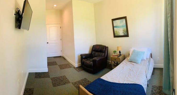 Cozy resident room with a bed and armchair