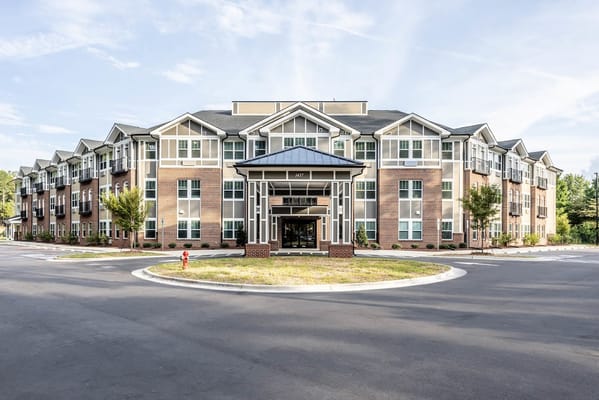 Exterior view of a senior living facility with landscaped grounds