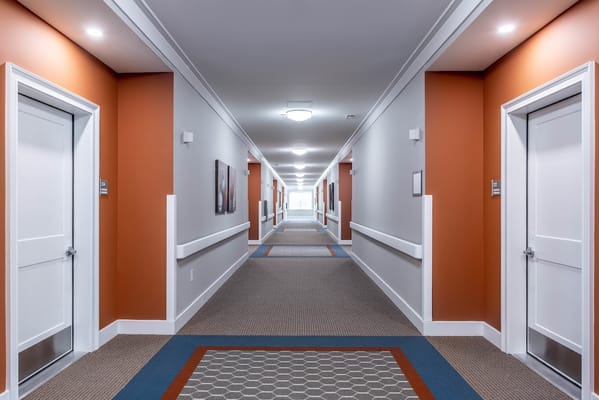 Brightly lit hallway in a modern assisted living facility