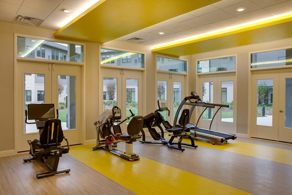 Bright fitness room with gym equipment