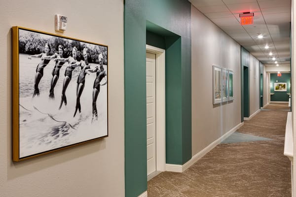 A hallway with vintage photos and art on the walls