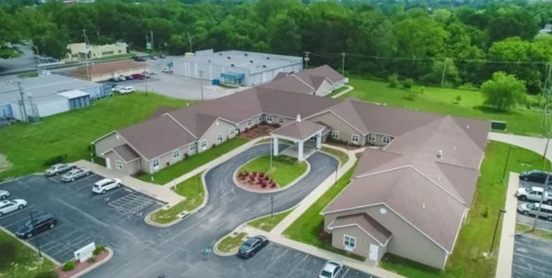Aerial view of the facility with landscaping and parking area