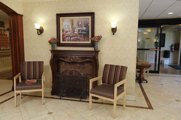 Seating area with two chairs and a decorative fireplace