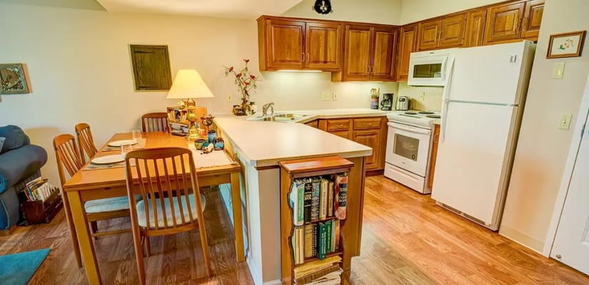 Kitchen with dining table and wooden cabinets