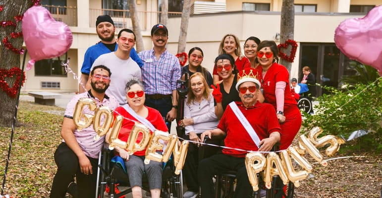 Residents and staff celebrating outdoors with decorations