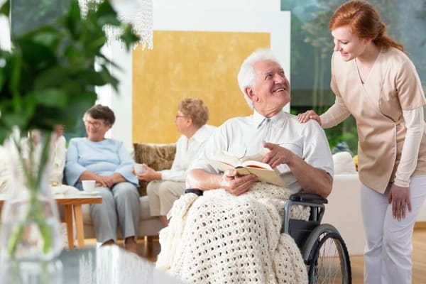 Resident reading a book in a cozy common area