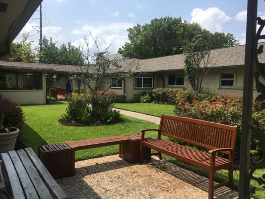A serene garden area with benches and landscaping