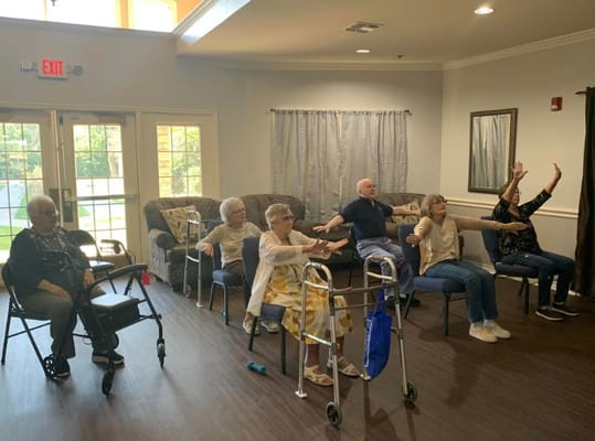 Seniors participating in an exercise class at Good Tree facility