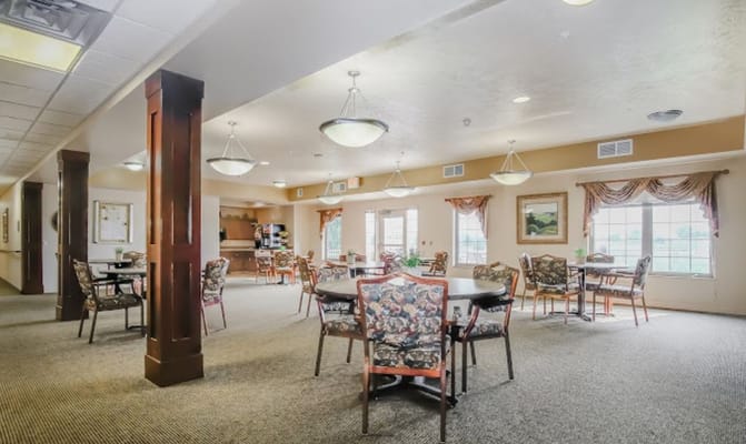 Common area of an assisted living facility with tables and chairs