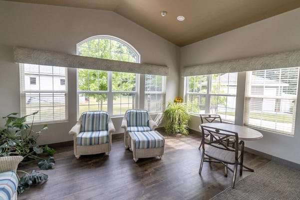 Cozy living room with striped chairs and large windows