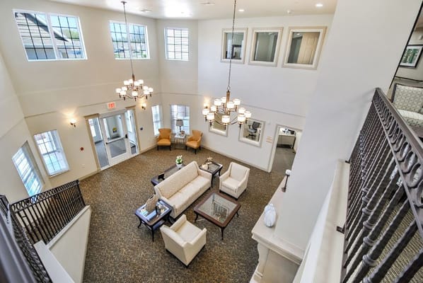 Bright and spacious lobby with seating area at Grandhaven Manor Communities.