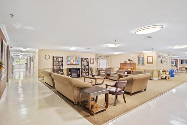 Cozy common area with seating and bookshelf