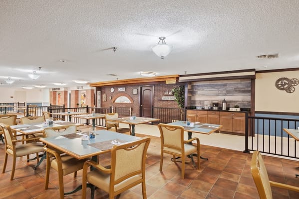Dining area with tables and a brick wall decor