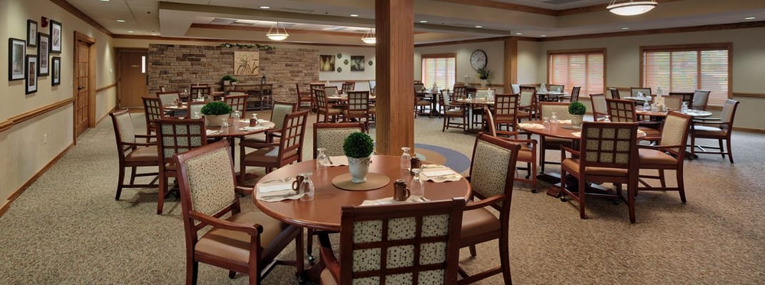 Spacious dining area with tables and chairs set for dining.