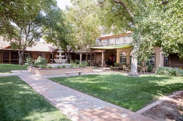 A peaceful outdoor space with a fountain and seating