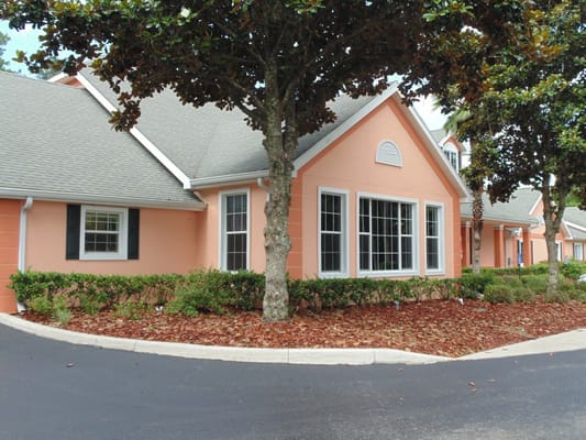 Peach-colored building exterior with landscaped garden