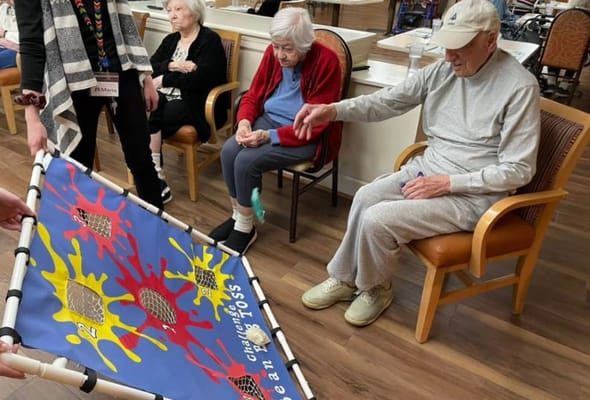 Residents participating in a bean toss game.