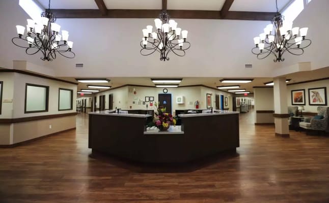 Interior lobby of Harlingen Nursing and Rehabilitation Center with chandelier and reception desk