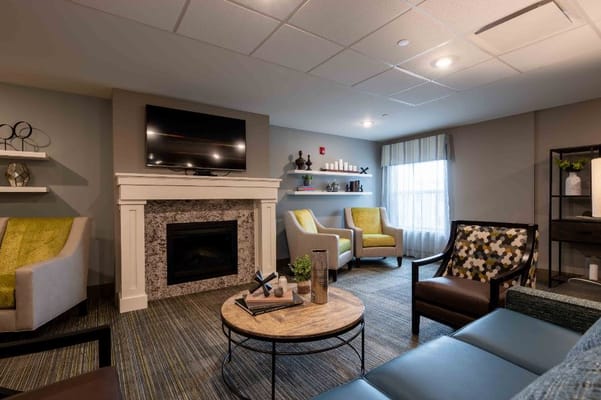 Cozy common area with seating and a fireplace