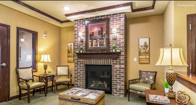Comfortable seating area with a fireplace and decorative artwork