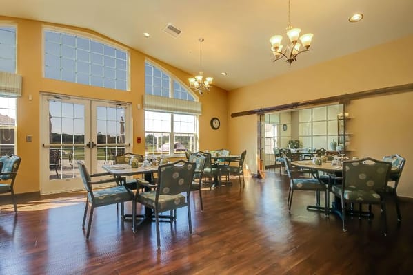Dining area with tables and chairs in Hathaway Hills Assisted Living.