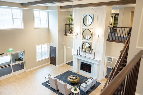 Bright and welcoming common area with seating and fireplace