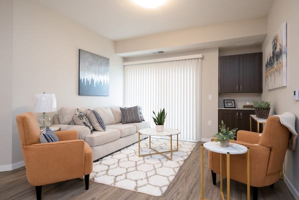 Bright and cozy living room with a sofa and two armchairs