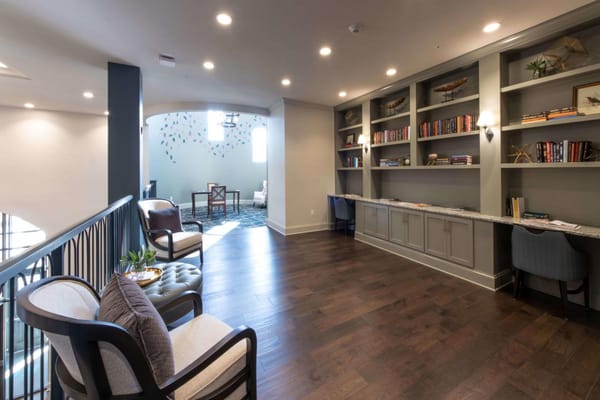 Cozy lounge area featuring bookshelves and comfortable seating