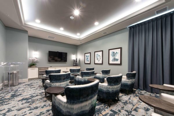 Lounge seating with blue chairs and artwork on the walls in Heartis Brookfield