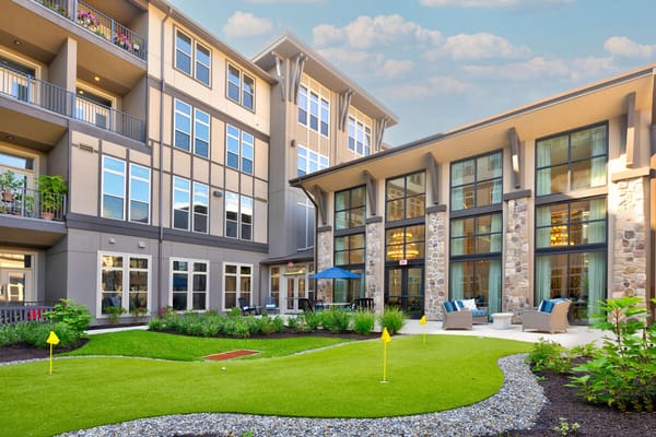 View of the courtyard at Heartis Bucks County with golf putting green and seating areas.