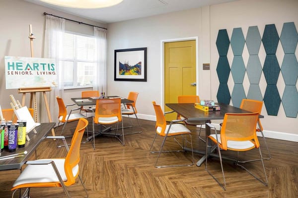 Bright activity room with tables and chairs