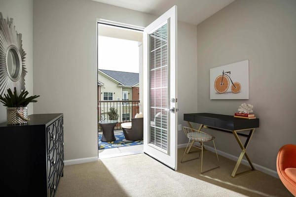 Bright interior room with an open door to the balcony