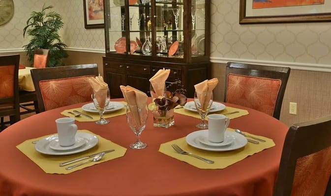 Table set for dining with dishes and silverware at Henley Place.