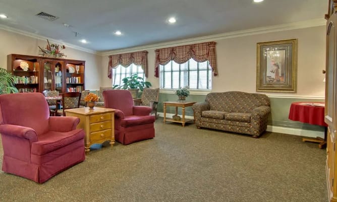 Cozy common room with chairs and a bookshelf