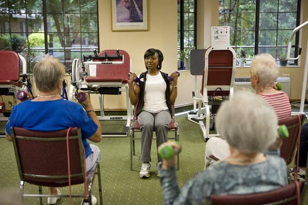Residents participating in a seated exercise class