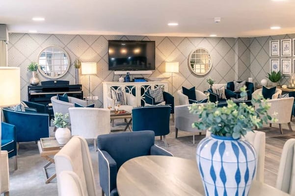 Modern lounge area with comfortable seating and a television.