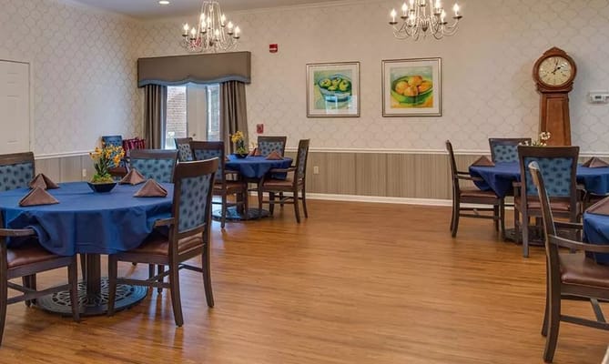 Cozy dining area with blue tablecloths and decorative plants.