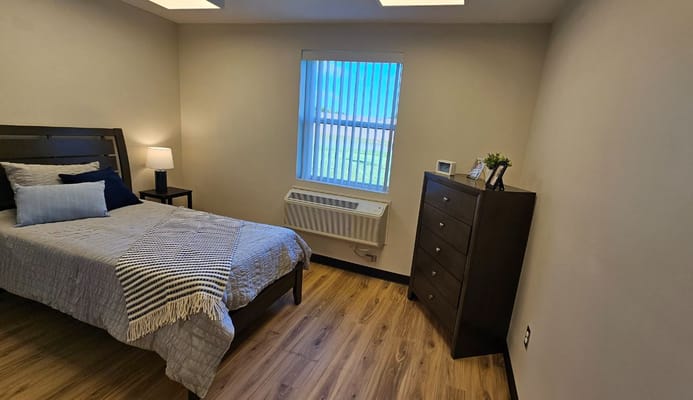Cozy private room with a bed and dresser