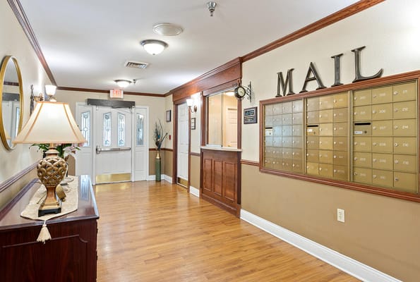 Interior view of the mail area with mailboxes and a lamp.