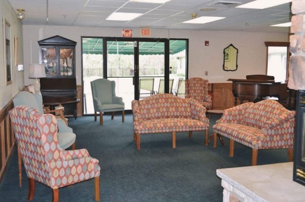 Common area with colorful seating and a piano
