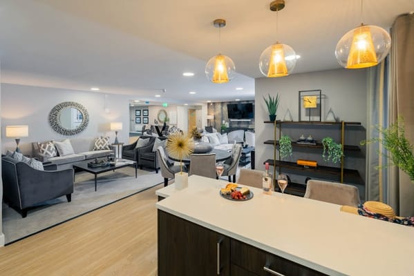 Modern lounge area with seating and decor in a retirement living facility.
