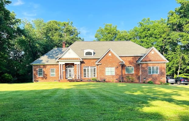 Exterior view of a residential care facility surrounded by greenery