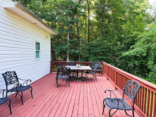 Outdoor deck with seating surrounded by trees