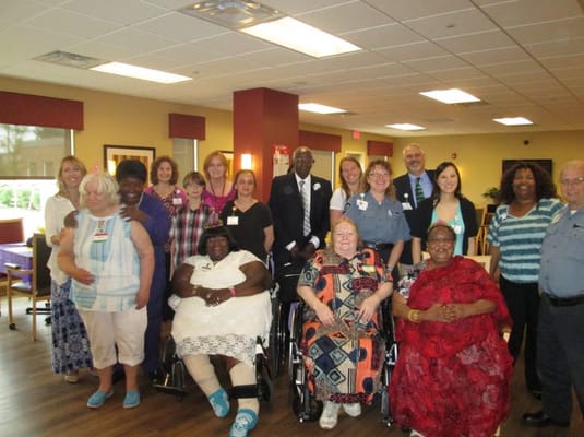 Staff and residents posing together in a common area