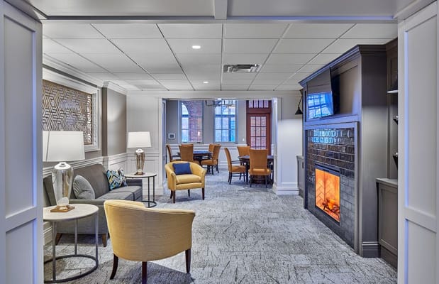 Inviting lounge area featuring comfortable seating and a fireplace.