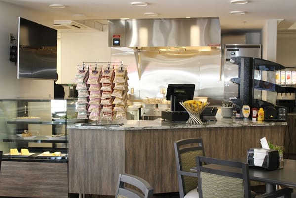 Bright dining area with a service counter and food display