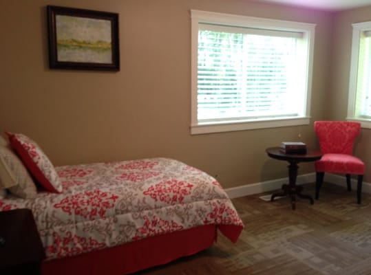 Private resident room with bed and chair